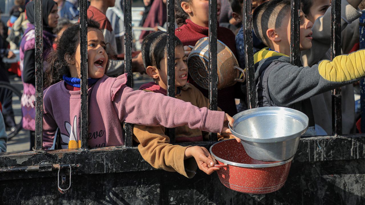Children try to get food relief in the southern Gaza Strip city of Rafah, on December 31, 2023. Rizek Abdeljawad/Xinhua/Getty Images